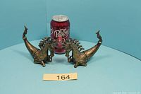 Pair of cast Batak medicine horns beside soda can for scale