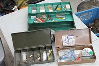 All three tackle boxes open showing interiors and contents
