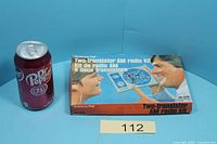 Boxed Science Fair two-transistor AM radio kit beside soda can for scale