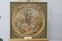 Front view of framed woven tapestry depicting pastoral scene
