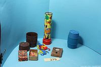 Group shot showing all vintage toys including kaleidoscope, two barrels, monkeys, Bubbling Baby box and figure, Video Scope