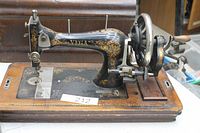 Full view of Vega hand crank sewing machine on wooden base