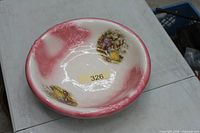 Top view of bowl showing pink rim, white center, transfer scenes