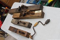Four wooden hand planes laid out on table