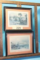 Two framed engravings stacked in display rack
