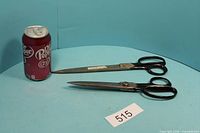 Both pairs of Wiss scissors beside soda can for scale