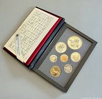 Open case showing seven proof coins and specification card