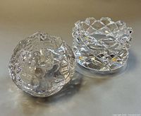 Both glass votive holders side by side showing overall forms and clarity
