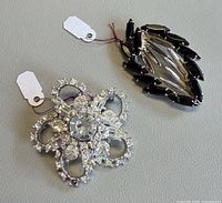 Both brooches front view with tags