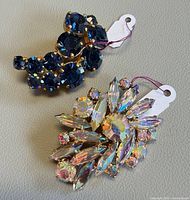 two brooches overview with tags visible