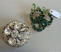 Front view of both brooches showing stone colors and settings