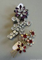 Both brooches front view showing colors, shapes and sizes