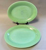 Front view showing both jadeite platters on stand and flat