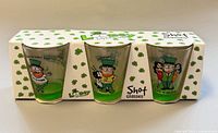 Front view of boxed set showing three shot glasses and graphics