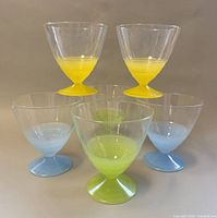 Six coloured-stem dessert cups grouped, front and side view