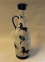 Full view of ceramic pitcher front, showing overall shape, decoration and condition