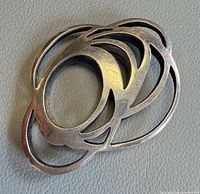 Front view showing abstract layered oval cut-out design