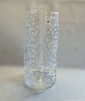 Full view of clear cylindrical textured glass vase
