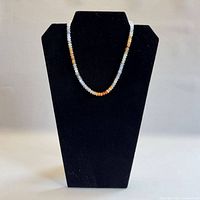 Full front view of opal bead necklace on display bust