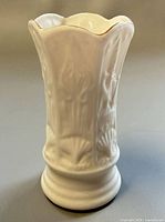 Front view of Belleek six-panel spill vase