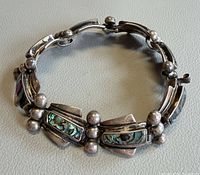 Front view of entire bracelet showing design, abalone inlay and overall condition