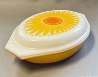 Closed casserole showing yellow base and sunflower lid