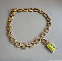 Full view of necklace laid flat showing links and pendant