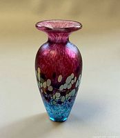Full view front of signed iridescent magenta-blue art glass vase
