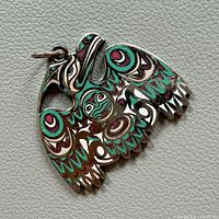 Front of enamelled raven pendant with jump ring