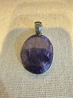 Front view of charoite pendant showing stone and bezel setting