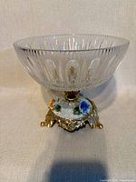 Full view of compote showing clear cut glass bowl and ornate base