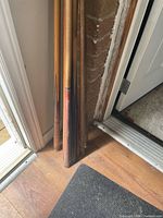 Nine cues leaning against wall by doorway showing overall lot