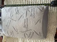 Top view of bamboo charcoal pillow with tape measure showing length