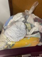 Sealed clear bag showing assorted blankets inside