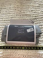 Front of packaged gray gift sack showing X-Large label and price sticker