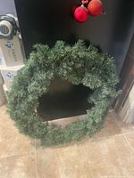 Front view of green artificial wreath showing full circumference and foliage density