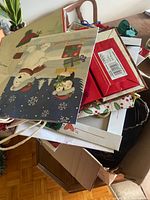 open cardboard box filled with assorted Christmas gift bags