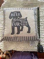 Front of pillow showing dog silhouette graphic and quote with measuring tape for scale