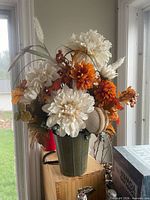 Full view of artificial fall floral arrangement in green ceramic pot
