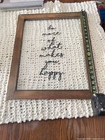 Front view of framed wall art with measuring tape showing height ~20 in