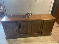 Front view of solid wood four-door buffet sideboard with carved panels