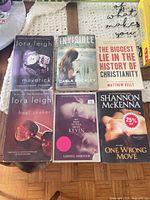 Six paperback books laid out front covers visible