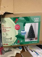 Box showing Holiday Living 5 ft pre-lit Sherwood Pine tree graphics and specifications