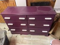 Front view of purple six-drawer dresser with white handles
