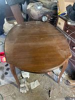 Top view of closed solid wood dining table showing overall shape and condition