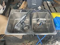 Top view of double basin sink with faucet and drain parts