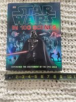 Front cover of Star Wars in 100 Scenes hardcover book with tape for scale