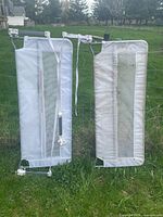 Both toddler bed rails front view hanging on fence