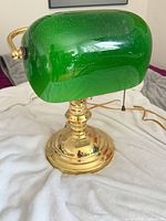 Full view of brass banker's lamp, cord visible