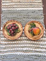 Both fruit wall plaques displayed side by side
